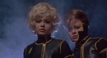 Movie still from “Planet of the Vampires” (1965), directed by Mario Bava – A couple of women standing next to each other; Close Up shot, Low angle