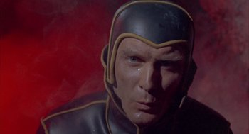 Movie still from “Planet of the Vampires” (1965), directed by Mario Bava – A man's face in a black and yellow costume; Close Up shot, Low angle