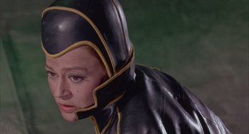 Movie still from “Planet of the Vampires” (1965), directed by Mario Bava – A woman wearing a black and yellow costume; Close Up shot, Low angle