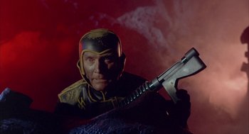 Movie still from “Planet of the Vampires” (1965), directed by Mario Bava – A person holding a gun; Medium shot, Low angle