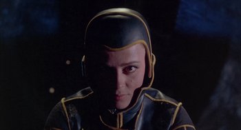 Movie still from “Planet of the Vampires” (1965), directed by Mario Bava – A person wearing a black and yellow helmet; Close Up shot, Low angle