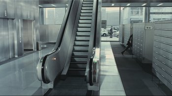 Movie still from “Playtime” (1967), directed by Jacques Tati – An escalator going up and down the side of a building; Extreme Wide shot, High angle