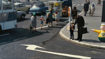 Movie still from “Playtime” (1967), directed by Jacques Tati – A group of people crossing the street in a busy city; Wide shot, High angle