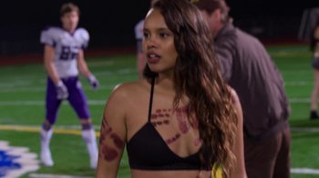 Movie still from “13 Reasons Why” (2017), created by Brian Yorkey – A woman in a black bikini top and some blood markings on her arms; Medium shot, High angle