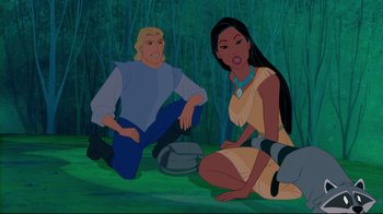 Movie still from “Pocahontas” (1995), directed by Mike Gabriel – A man and a woman sitting on the ground in front of a forest; Medium shot, High angle