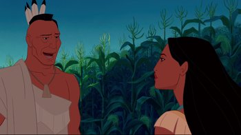 Movie still from “Pocahontas” (1995), directed by Mike Gabriel – Two women are standing in front of a corn field; Medium shot, Over the shoulder angle