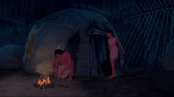 Movie still from “Pocahontas” (1995), directed by Mike Gabriel – A couple of people that are standing in front of a fire; Wide shot, High angle
