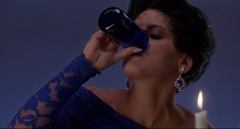 Movie still from “Poetic Justice” (1993), directed by John Singleton – A woman in a blue dress drinking from a blue bottle; Close Up shot, High angle