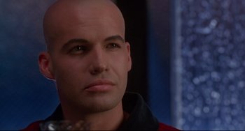 Movie still from “Poetic Justice” (1993), directed by John Singleton – A man with bald head looking into the distance; Close Up shot, Over the shoulder angle