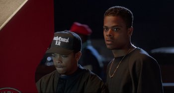 Movie still from “Poetic Justice” (1993), directed by John Singleton – Two young men standing next to each other in a dark room; Close Up shot, Over the shoulder angle