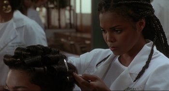 Movie still from “Poetic Justice” (1993), directed by John Singleton – A woman is cutting her hair with a pair of scissors; Close Up shot, Over the shoulder angle
