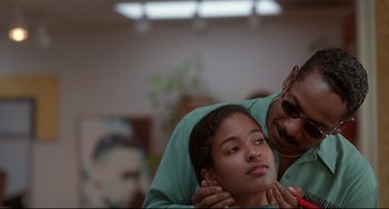 Movie still from “Poetic Justice” (1993), directed by John Singleton – A man and a woman are touching each other's hair; Close Up shot, Low angle