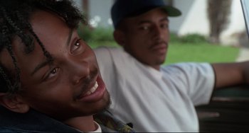 Movie still from “Poetic Justice” (1993), directed by John Singleton – Two men sitting next to each other in a field; Close Up shot, Over the shoulder angle