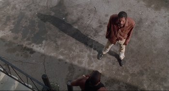 Movie still from “Poetic Justice” (1993), directed by John Singleton – An overhead view of a man walking on the sidewalk; Wide shot, Low angle