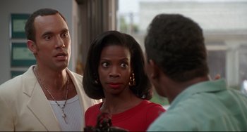 Movie still from “Poetic Justice” (1993), directed by John Singleton – A woman in a red dress talking to two other men; Close Up shot, Over the shoulder angle