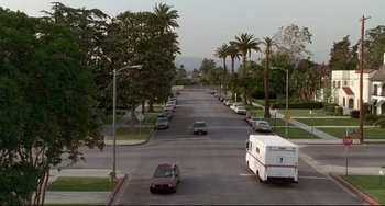 Movie still from “Poetic Justice” (1993), directed by John Singleton – Cars driving down a street lined with palm trees; Extreme Wide shot, High angle