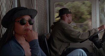 Movie still from “Poetic Justice” (1993), directed by John Singleton – A man and a woman riding on a train; Close Up shot, Low angle