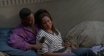 Movie still from “Poetic Justice” (1993), directed by John Singleton – A man and a woman sitting next to each other; Medium shot, Over the shoulder angle