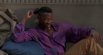 Movie still from “Poetic Justice” (1993), directed by John Singleton – A man in a purple shirt combing his hair; Close Up shot, High angle