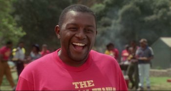 Movie still from “Poetic Justice” (1993), directed by John Singleton – A person wearing a pink t - shirt; Close Up shot, Low angle
