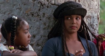 Movie still from “Poetic Justice” (1993), directed by John Singleton – A woman wearing a black hat is talking to another woman; Close Up shot, Over the shoulder angle