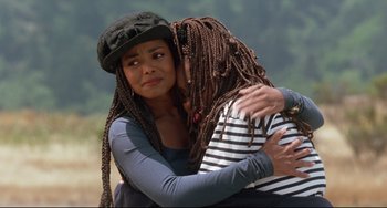 Movie still from “Poetic Justice” (1993), directed by John Singleton – Two women embracing each other in a wooded area; Close Up shot, High angle