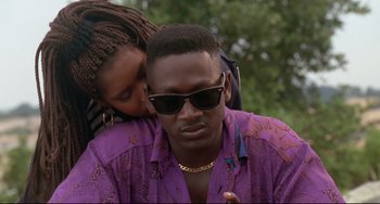 Movie still from “Poetic Justice” (1993), directed by John Singleton – A man and a woman are kissing in a park; Close Up shot, Low angle