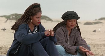 Movie still from “Poetic Justice” (1993), directed by John Singleton – Two women sitting on the beach looking at each other; Close Up shot, High angle