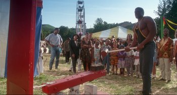 Movie still from “Poetic Justice” (1993), directed by John Singleton – A group of people standing in a field with an axe; Wide shot, Low angle