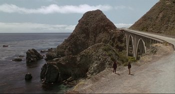 Movie still from “Poetic Justice” (1993), directed by John Singleton – Two people are walking on a path near the ocean; Extreme Wide shot, High angle