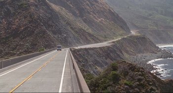 Movie still from “Poetic Justice” (1993), directed by John Singleton – A car driving down the side of a mountain road; Extreme Wide shot, High angle
