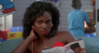 Movie still from “Poetic Justice” (1993), directed by John Singleton – A woman in a red top is reading a book; Close Up shot, Over the shoulder angle