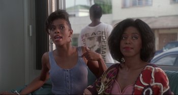Movie still from “Poetic Justice” (1993), directed by John Singleton – Two women sitting next to each other on a bus; Medium shot, Over the shoulder angle