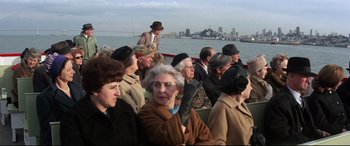 Movie still from “Point Blank” (1967), directed by John Boorman – A group of people sitting on top of a boat in the water; Wide shot, High angle