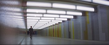Movie still from “Point Blank” (1967), directed by John Boorman – A person is standing in a hallway with lights on the ceiling; Extreme Wide shot, Low angle