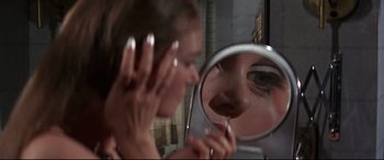 Movie still from “Point Blank” (1967), directed by John Boorman – A woman looking in the mirror while brushing her teeth; Extreme Close Up shot, Low angle
