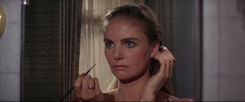 Movie still from “Point Blank” (1967), directed by John Boorman – A woman putting on a pair of eye lashes; Close Up shot, Over the shoulder angle