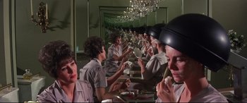 Movie still from “Point Blank” (1967), directed by John Boorman – A group of people sitting at a dinner table eating food; Medium shot, Low angle