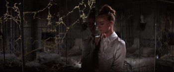 Movie still from “Point Blank” (1967), directed by John Boorman – A woman standing in front of a glass wall; Medium shot, Low angle