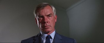 Movie still from “Point Blank” (1967), directed by John Boorman – A person wearing a suit and tie; Close Up shot, Low angle