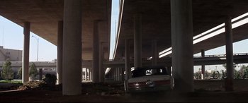 Movie still from “Point Blank” (1967), directed by John Boorman – A car parked in a parking lot under a bridge; Extreme Wide shot, Low angle