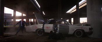 Movie still from “Point Blank” (1967), directed by John Boorman – A car that is sitting in a parking lot; Wide shot, Low angle