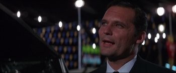 Movie still from “Point Blank” (1967), directed by John Boorman – A man in a suit and tie looking up; Close Up shot, Low angle