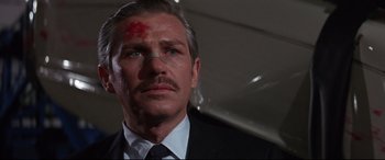 Movie still from “Point Blank” (1967), directed by John Boorman – A person wearing a suit and tie; Close Up shot, Low angle