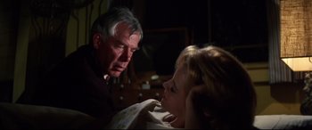 Movie still from “Point Blank” (1967), directed by John Boorman – An older man and a younger woman looking at each other; Medium shot, Over the shoulder angle