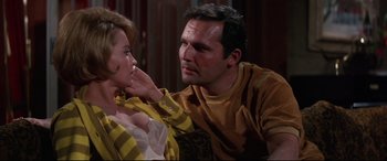 Movie still from “Point Blank” (1967), directed by John Boorman – A man and a woman sitting next to each other on a couch; Close Up shot, Low angle