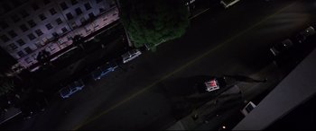 Movie still from “Point Blank” (1967), directed by John Boorman – An overhead view of a street at night; Extreme Wide shot, Overhead angle