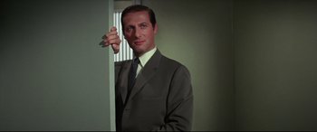 Movie still from “Point Blank” (1967), directed by John Boorman – A man in a suit and tie leaning against a wall; Close Up shot, Low angle