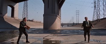 Movie still from “Point Blank” (1967), directed by John Boorman – A view of a bridge from underneath a bridge; Extreme Wide shot, High angle