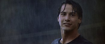 Movie still from “Point Break” (1991), directed by Kathryn Bigelow – A person wearing a black shirt; Close Up shot, Low angle